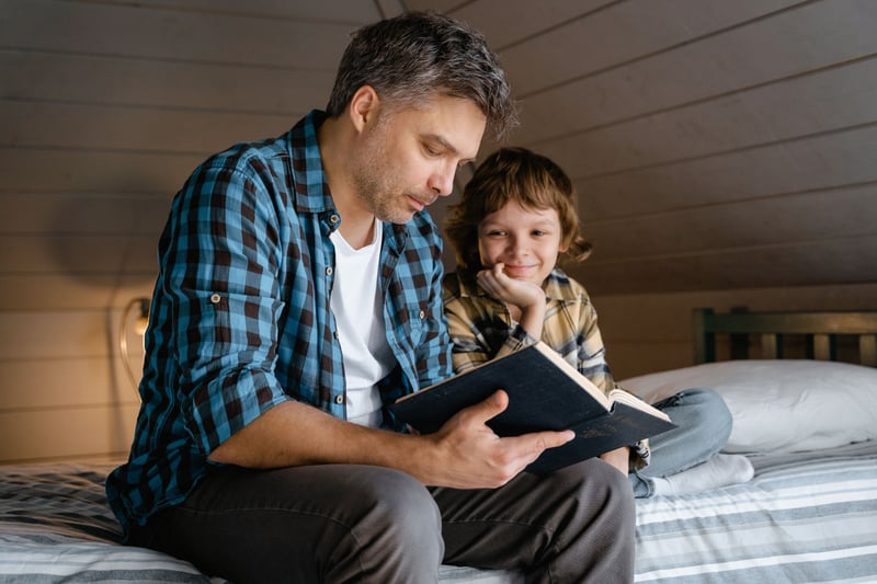 Father reading bedtime story to child