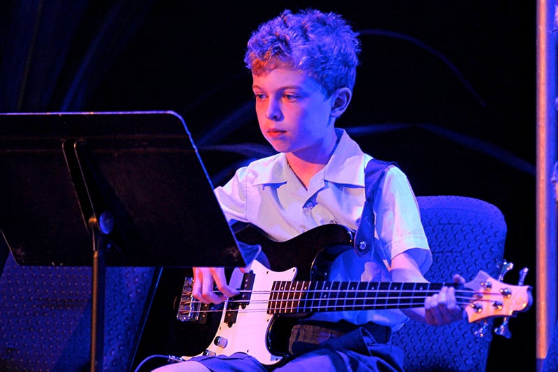A King's kid playing electric guitar