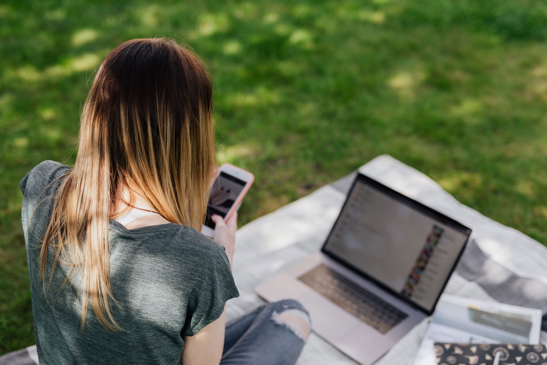 Teen using a phone and computer